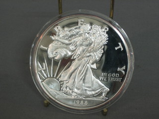 A 1988 American silver proof medallion, marked One Half Pound of Fine Silver 999, 8ozs