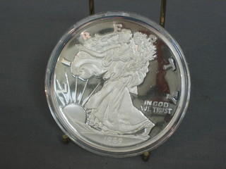 A 1989 American silver proof medallion, marked One Half Pound of Fine Silver 999, 8ozs