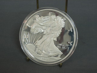 A 1990 American silver proof medallion, marked One Half Pound of Fine Silver 999, 8ozs