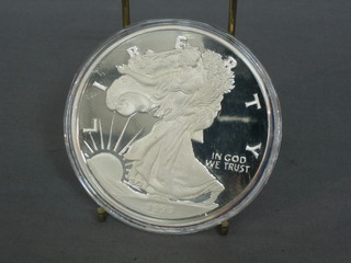 A 1995 American silver proof medallion, marked One Half Pound of Fine Silver 999, 8ozs