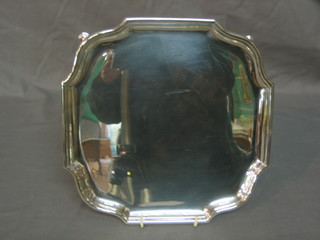A square silver plated salver with bracketed border raised on hoof feet 10"