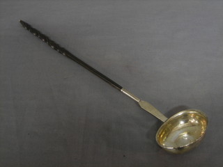 A Georgian silver ladle with whale bone twist handle (f & r)
