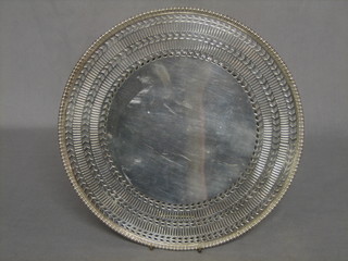 A circular pierced silver plated platter raised on a spreading foot