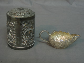 An Eastern cylindrical silver plated jar and cover together with a small sauce boat with cobra handle