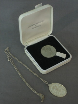 A silver chain hung a pendant to commemorate teh wedding of Charles and Diana together with a wedding medallion