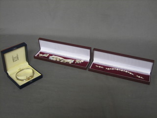 A Royal Mint silver bracelet decorated birds and 2 pearl bracelets (3) all cased