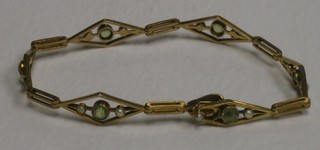 A Victorian 9ct gold bracelet set peridots and pearls