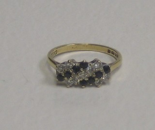 A 9ct gold dress ring set 8 sapphires supported by diamonds