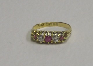 An 18ct gold dress ring set 2 diamonds supported by 3 rubies