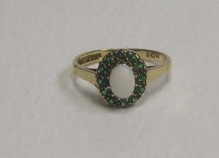 A 9ct gold dress ring set an oval cut "opal" surrounded by gemstones