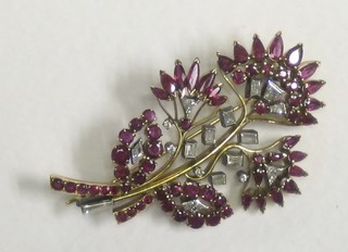 A lady's attractive gold floral spray brooch set rubies and diamonds
