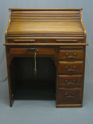 A Victorian mahogany roll top desk with fitted interior, fitted 1 long drawer and 4 short drawers to the side, 36"