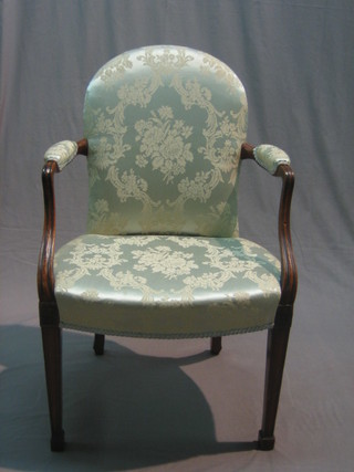 A Georgian mahogany open arm chair upholstered in blue material, raised on square tapering supports ending in spade feet