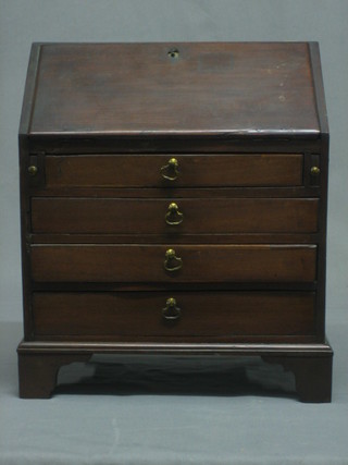 A 19th/20th Century miniature Georgian style bureau, the fall front revealing a fitted interior above 4 long graduated drawers  with brass drop handles to the sides, raised on bracket feet 12"