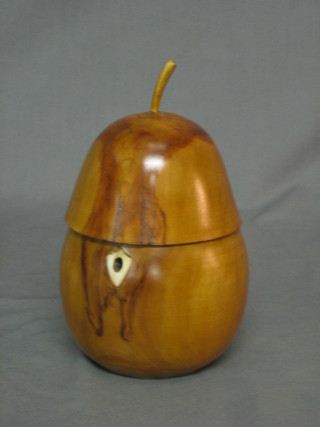A turned fruit wood caddy in the form of an apple with ivory escutcheon 5"