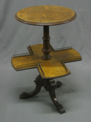 A Victorian circular walnut table, the base with cross shaped sewing shelf and brass gallery, raised on pillar and tripod supports 16"