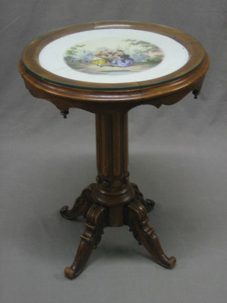 A 19th Century circular Continental walnut wine table, the top inlaid a porcelain panel, raised on turned and reeded supports with cabriole base 17"