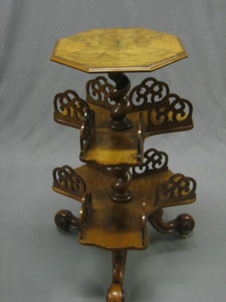 A Victorian octagonal figured walnut sewing table with 2 revolving shelves beneath 14"