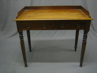 A Victorian bleached mahogany wash stand with three-quarter gallery, the base fitted 2 long drawers, raised on turned supports 36"