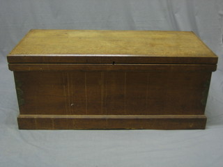 An oak coffer with hinged lid, raised on a platform base 45"