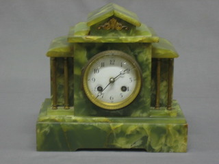 A Victorian French 8 day striking mantel clock with enamelled dial and Arabic numerals contained in a green marble case
