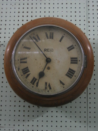 A wall clock, the 10" painted dial with Roman numerals contained in an oak case marked Reid