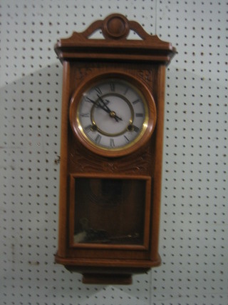 A reproduction Victorian style striking wall clock with 5" dial contained in a carved oak case