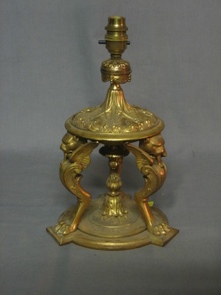 A gilt ormolu table lamp supported by 3 griffins 11"