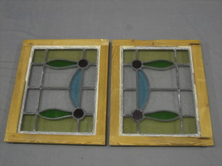 A pair of 1930's stained glass windows contained in pine frames 20"x17"