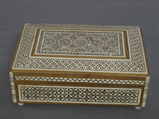 An inlaid Moorish hardwood box with hinged lid on ivory feet 5"