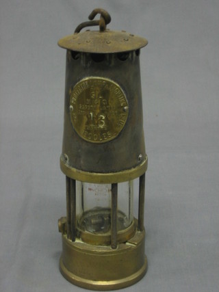 A Miner's Davey lamp marked The Protector Lamp Type SLM & Q 30-50