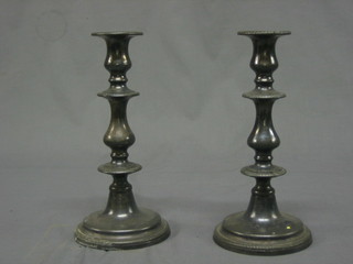 A pair of 18th/19th Century pewter candlesticks with ejectors 9"