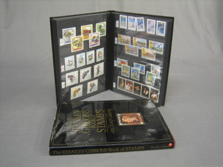 An album of various Continental stamps and 1 vol. "The Stanley Gibbon Book of Stamps and Collecting"
