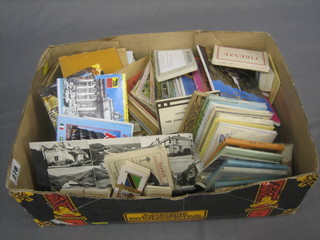 A collection of various coloured postcards etc