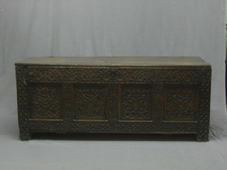A 17th/19th Century carved oak coffer of panelled construction with hinged lid, the interior fitted a candle drawer, carved throughout (with new base) 60"