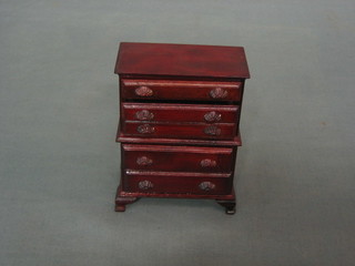 A dolls house mahogany bow front chest on chest fitted 3 long drawers above 2 short drawers, raised on bracket feet 3"