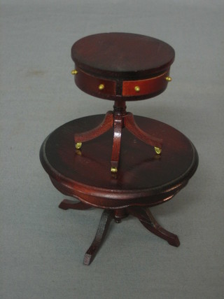 A dolls house circular mahogany drum table raised on pillar and tripod supports 2" and a circular mahogany pedestal dining table 3"