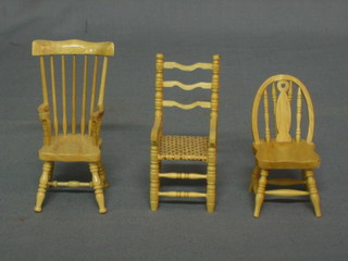 A dolls house pine kitchen carver chair, a ladder back chair and a wheel back chair