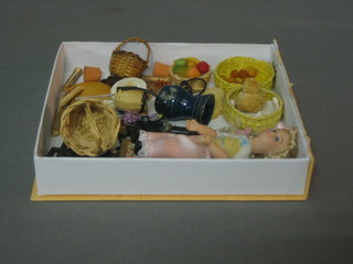 A collection of various miniature dolls house items including baskets, loaves of bread, logs and etc