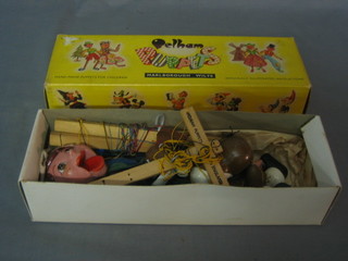 A Pelham Puppet of a boy together with a Pelham Puppet of a dog contained in a cardboard box marked Peter Pan