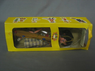 A Pelham Puppet of a girl contained in a cardboard box marked Red Riding Hood