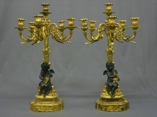 A handsome pair of gilt Ormolu 5 light candelabrum with detachable sconces, the bases decorated seated cherub depicting music and literature 27" (re-gilded)