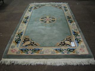 A Chinese green and floral patterned rug (slight stain) 87"x48"