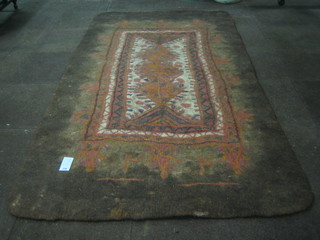 A Persian felt rug with floral decoration to the centre 97"x64"