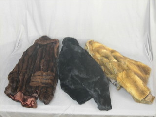 A lady's French black rabbit jacket together with other fur coats