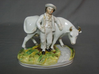 A 19th Century Staffordshire figure of a standing gentleman with cow 7"
