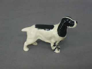 A Beswick figure of a standing black and white Spaniel 3"
