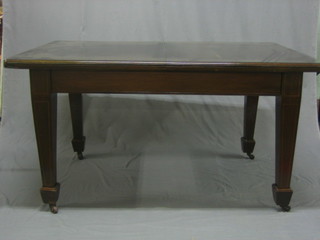 An Edwardian rectangular mahogany extending dining table with 2 extra leaves, raised on square tapering supports 92" long