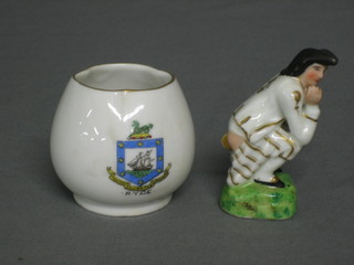 A Continental porcelain figure of a crouching man 3" together with a crested china vase, decorated the Arms of the Realm (2)