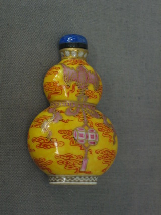 An Oriental yellow double gourd shaped snuff bottle decorated The Imperial Palace, the base with 4 character seal